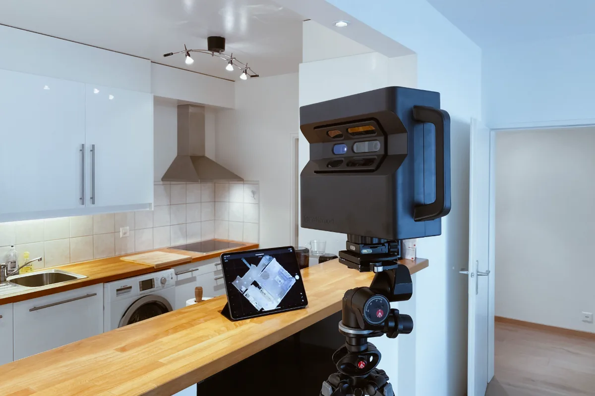 Matterport Pro camera on a tripod scanning a modern kitchen, with the capture app running on an iPad